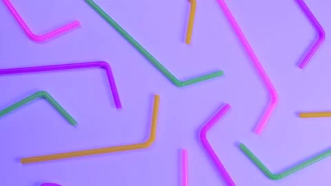 Rotating multi-colored cocktail straws on a purple background, top view, the Stock Footage 215612066