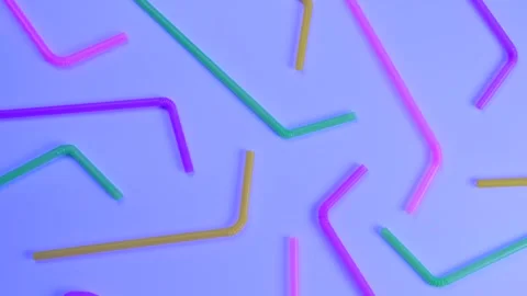 Rotating multi-colored cocktail straws on a blue background, top view, the Stock Footage 250422739
