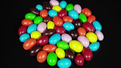 Rotating Multicolored Chocolate Dragees Covered With Sugar On A Black Backgr Stock Footage 235521318