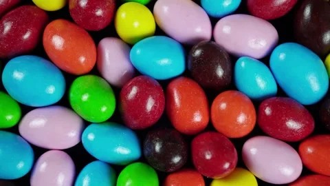 Rotating Multicolored Chocolate Dragees Covered with Sugar. Видео 235521769