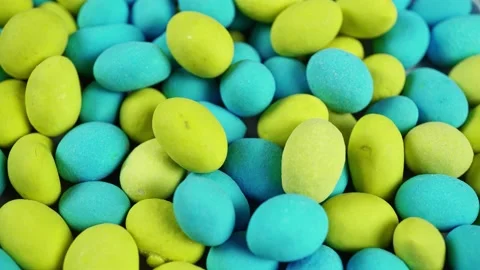 Rotating Multicolored Dragee In Colored Matte Glaze. Stock Footage 235521693