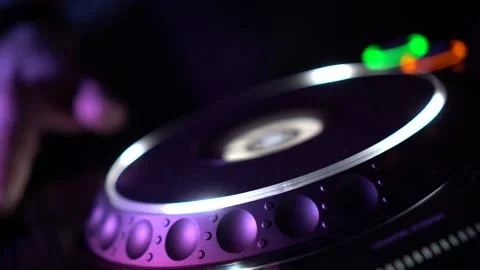Rotating music record on a DJ console in a disco. Footage. Close-up of musical Stockbeeldmateriaal 148195199