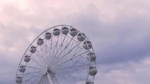 Rotating nostalgic Ferris Wheel - sunset cloudy sky - real time Stock Footage 140632942