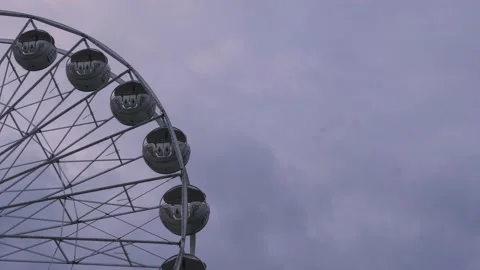 Rotating nostalgic Ferris Wheel - sunset cloudy sky - real time Stock Footage 140633258