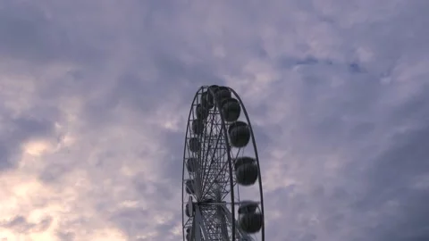 Rotating nostalgic Ferris Wheel - sunset cloudy sky - time lapse Stock Footage 140636319
