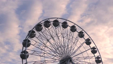 Rotating nostalgic Ferris Wheel - sunset cloudy sky - real time Stock Footage 140644556