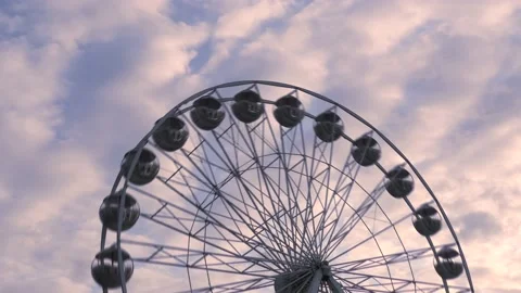 Rotating nostalgic Ferris Wheel - sunset cloudy sky - time lapse Stock Footage 140644567