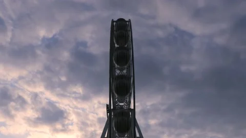 Rotating nostalgic Ferris Wheel - sunset cloudy sky - time lapse Stock Footage 140655700