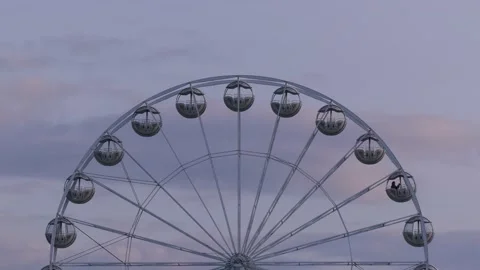 Rotating nostalgic Ferris Wheel - sunset cloudy sky - real time Stock Footage 140679069