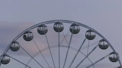 Rotating nostalgic Ferris Wheel - sunset cloudy sky - real time Stock Footage 140681545