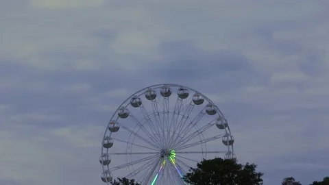 Rotating nostalgic Ferris Wheel - sunset cloudy sky - time lapse Stock Footage 140726160