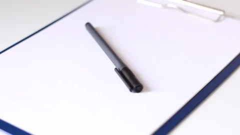 Rotating notebook with pen over it Stock Footage 86230818