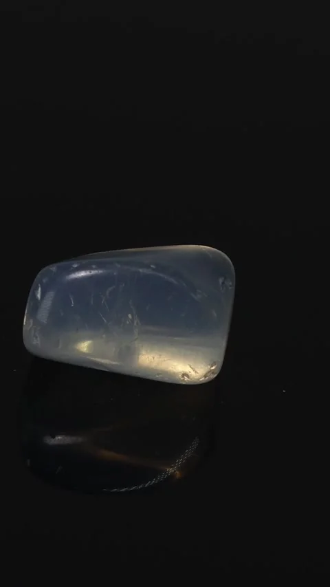 Rotating Opal on Dark Surface Stock Footage 304941391