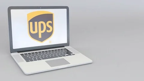 Rotating opening and closing laptop with United Parcel Service UPS logo Stock Footage 73099537