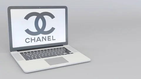 Rotating opening and closing laptop with Chanel logo. Computer technology Stock Footage