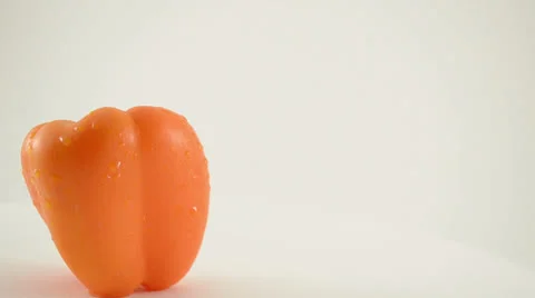 Rotating Orange Pepper Against White - Crane Down Video stock 22648655