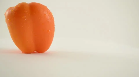 Rotating Orange Pepper Against White - Crane Up Stock Footage 22648659