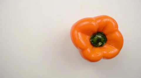 Rotating Orange Pepper Against White - Overhead Dolly Left Stock Footage 22803525