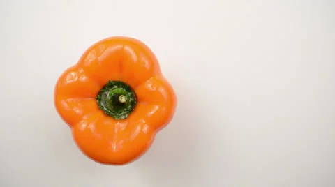 Rotating Orange Pepper Against White - Overhead Dolly Right Stock Footage 22803552
