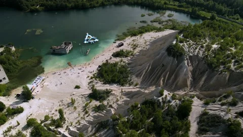 Rotating orbit video shot of unique lagoon surrounded by sand dune formation Stock Footage 224527444