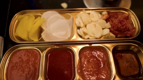 Rotating Overhead View of Korean BBQ Side Dishes and Sauces 库存影片 318767949