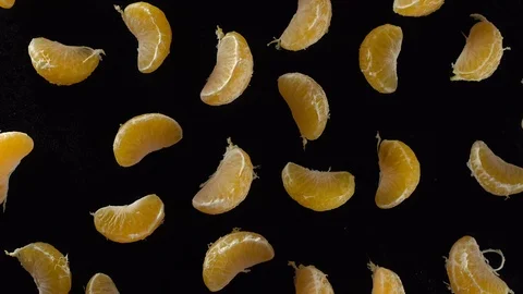 Rotating peeled tangerine slices Видео 69934375