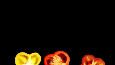Rotating Pepper Slices with Copy Space on Black Background in 60p Stock Footage 337682156