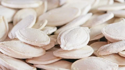Rotating pile of hulled pumpkin seeds close-up Stock Footage 344949785