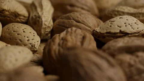 Rotating pile of mixed nuts peanuts walnuts and almonds Stock Footage 327911432