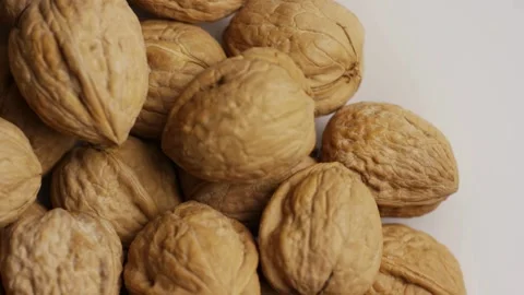 Rotating pile of whole walnuts in shells top view 動画素材 328085782