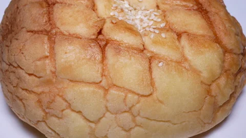 Rotating of pineapple bun on white background with 4k resolution. Stock Footage 99274933