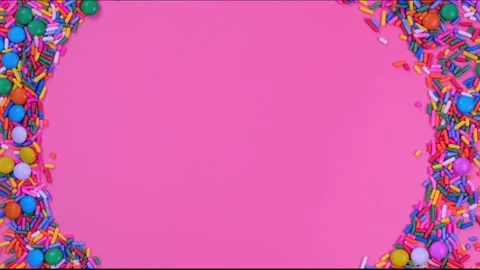 Rotating pink background with candies and sprinkles with place for text or copy Stock Footage 197547984
