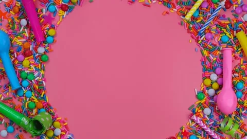 Rotating pink background with candies, balloons and pipes for a celebrated Stock Footage 197304515