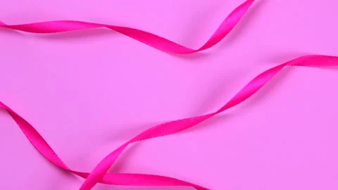 Rotating pink background with pink ribbons, newborn baby girl birthday Stock Footage 201259389