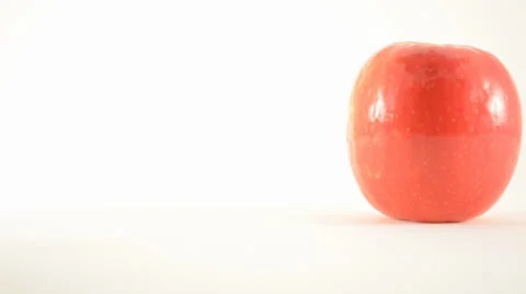 Rotating Pink Lady Apple Against White - Dolly Left Stock Footage 24470943