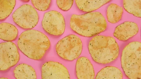 Rotating pink with potato chips close up .fashion,food background Stock Footage 197077136