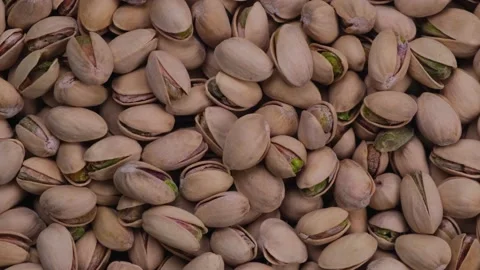 Rotating pistachios background top view close-up Stock Footage 197526777