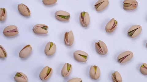 Rotating pistachios on a white background close-up Stock Footage 246906302