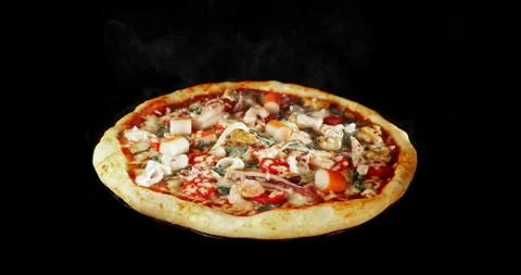 Rotating pizza during the baking process, isolated on a black background. Stock Footage 328468993
