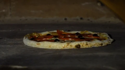 Rotating pizza with shovel inside big restaurant oven in slow motion Stock Footage 102382444