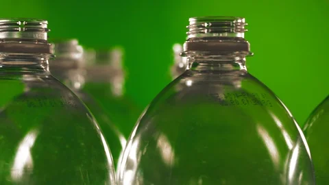Rotating plastic bottles on a green background. Close-up Stock Footage 122854811