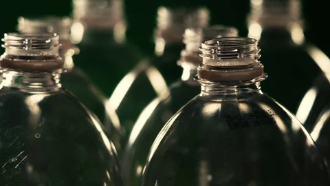 Rotating plastic bottles on a green background. Close-up Stock Footage 122857751