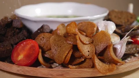 Rotating plate with bowl of soup, bread crackers and fresh vegetables Stock Footage 124384424