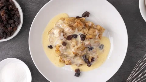 Rotating Plate of Bread Pudding and Custard Sauce Video stock 171175593