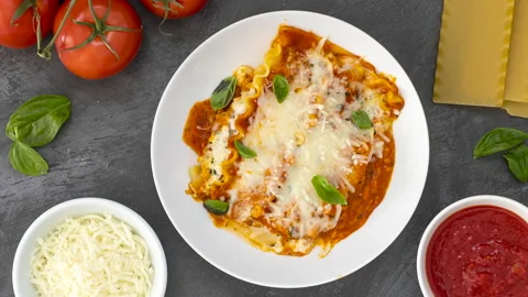 Rotating Plate of Cheese Lasagna in a Red Sauce Stock Footage 170631630