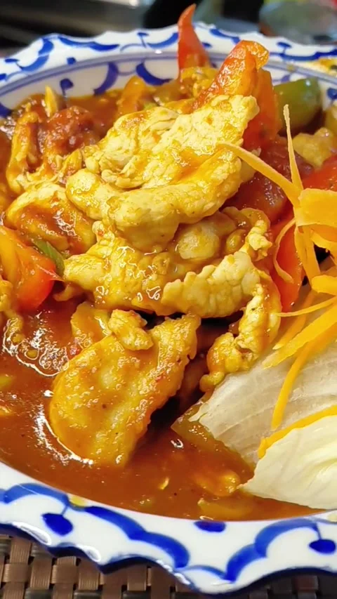 Rotating Plate of Chicken in Red Curry Sauce with Fresh Vegetables, Macro Stock Footage 340013057