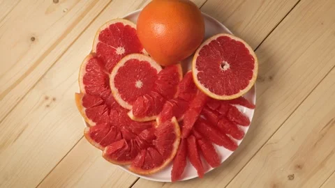 Rotating plate with fresh sliced grapefruit Stock Footage 341281004