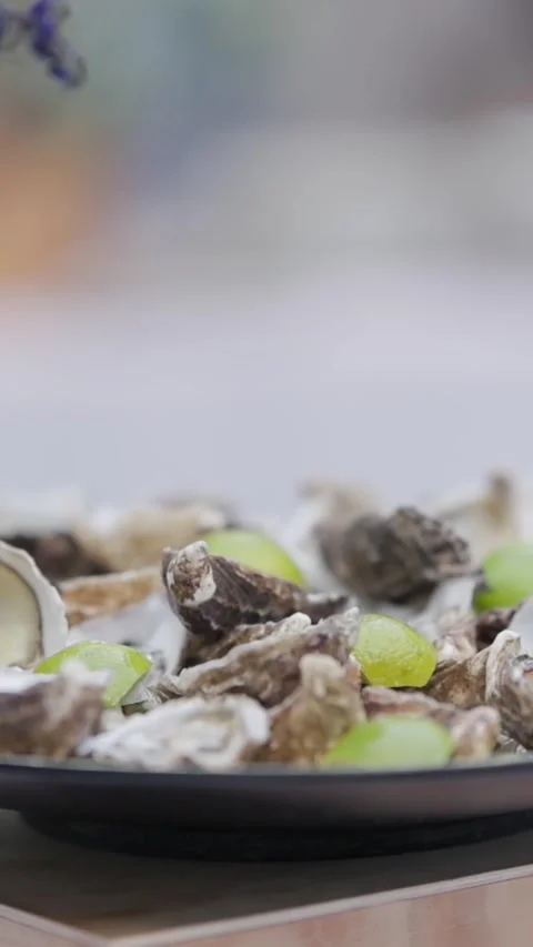 Rotating plate of oysters and lime wedges at a celebration Stock Footage 327806007