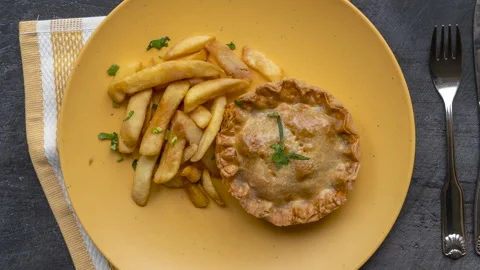 Rotating Plate of Steak and Kidney Pie with Chips Stock Footage 239961701