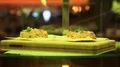 Rotating plate with two pastry in sweets shop HD Footage